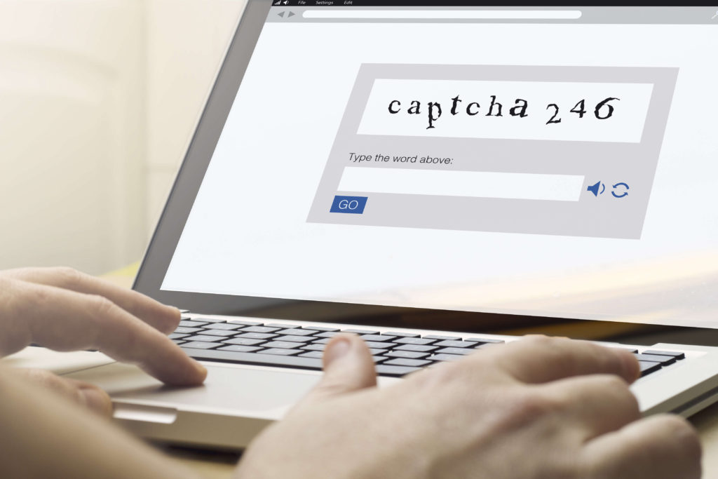 Close up of hands typing Captcha